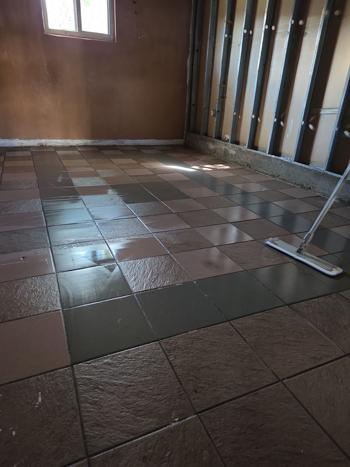Room stripped to bare block walls and open ceiling framing after water damage